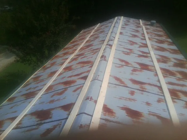 Rusted metal roof panels with new wood purlins before replacement — Storm Damage Roof Repair in Lake Harmony by Roofing Brothers