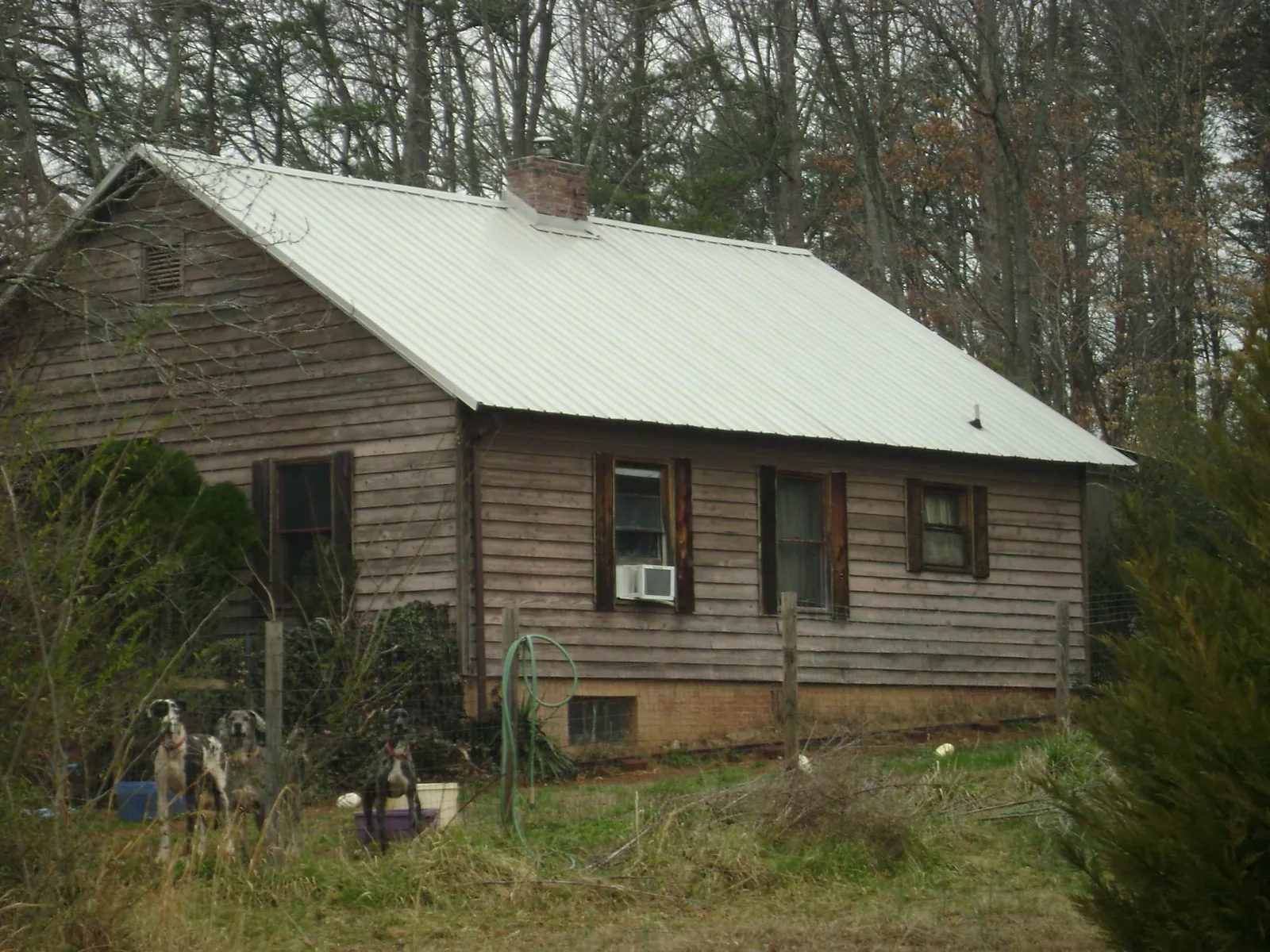 White metal roof on an old wood sided farmhouse, from a Metal Roof Installation job in Lake Harmony